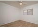 Simple bedroom featuring wood-look floors and a ceiling fan at 15819 W Crocus Dr, Surprise, AZ 85379