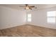 Bright bedroom with tile flooring and two windows at 15819 W Crocus Dr, Surprise, AZ 85379