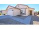 Front view of house with a two-car garage and walkway at 15819 W Crocus Dr, Surprise, AZ 85379