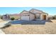 Single-story house with a two-car garage and desert landscaping at 15819 W Crocus Dr, Surprise, AZ 85379