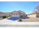 House exterior with a two-car garage and desert landscaping at 15819 W Crocus Dr, Surprise, AZ 85379