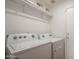 Laundry room with Whirlpool washer and dryer at 15819 W Crocus Dr, Surprise, AZ 85379