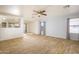 Bright living room with tile floors and ceiling fan at 15819 W Crocus Dr, Surprise, AZ 85379