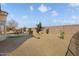 Large backyard with gravel and a small sitting area at 15920 W Summerwalk Dr, Surprise, AZ 85374