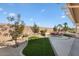 Landscaped backyard with patio furniture and covered patio at 15920 W Summerwalk Dr, Surprise, AZ 85374