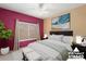 Virtually staged bedroom with large bed and neutral decor at 15920 W Summerwalk Dr, Surprise, AZ 85374