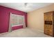 Bright bedroom with window, carpet, and built-in wooden cabinet at 15920 W Summerwalk Dr, Surprise, AZ 85374