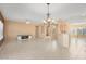 Open dining room with tile flooring and chandelier at 15920 W Summerwalk Dr, Surprise, AZ 85374