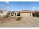 Single-story home with desert landscaping, two-car garage, and neutral exterior at 15920 W Summerwalk Dr, Surprise, AZ 85374