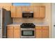 Stainless steel appliances and light wood cabinets in kitchen at 15920 W Summerwalk Dr, Surprise, AZ 85374