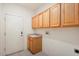 Laundry room with built in cabinets and sink at 15920 W Summerwalk Dr, Surprise, AZ 85374