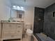 Modern bathroom with granite vanity, updated fixtures and a large walk-in shower at 1633 N 62Nd Ave, Phoenix, AZ 85035