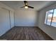 Bright bedroom with wood-look flooring and ceiling fan at 1633 N 62Nd Ave, Phoenix, AZ 85035