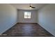 Spacious bedroom with wood-look flooring and ceiling fan at 1633 N 62Nd Ave, Phoenix, AZ 85035