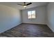 Spacious bedroom with wood-look flooring and ceiling fan at 1633 N 62Nd Ave, Phoenix, AZ 85035