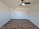 Bright bedroom with wood-look flooring and ceiling fan at 1633 N 62Nd Ave, Phoenix, AZ 85035