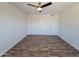 Well-lit bedroom with wood-look flooring and ceiling fan at 1633 N 62Nd Ave, Phoenix, AZ 85035