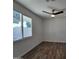 Bright bedroom with wood-look flooring and ceiling fan at 1633 N 62Nd Ave, Phoenix, AZ 85035