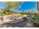 Landscaped backyard featuring a fire pit, seating area, and putting green at 1646 W Ainsworth Dr, Anthem, AZ 85086