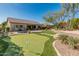 Backyard view showcasing a putting green and home exterior at 1646 W Ainsworth Dr, Anthem, AZ 85086