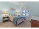 Bright bedroom with a queen bed, nightstands, and large window at 1646 W Ainsworth Dr, Anthem, AZ 85086