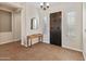 Bright entryway with tiled floors, a console table, and dark wood door at 1646 W Ainsworth Dr, Anthem, AZ 85086