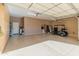 Spacious garage with golf cart, storage cabinets, and epoxy floor at 1646 W Ainsworth Dr, Anthem, AZ 85086