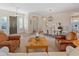 Open living and dining area with leather chairs and a wooden coffee table at 1646 W Ainsworth Dr, Anthem, AZ 85086