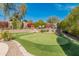 Private putting green in the backyard, perfect for practicing your short game at 1646 W Ainsworth Dr, Anthem, AZ 85086