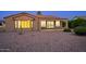 Desert landscaping surrounds this single-story home with a covered patio at 19724 N Jojoba Ct, Surprise, AZ 85374