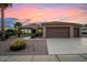 Single-story home with a two-car garage and desert landscaping at 19724 N Jojoba Ct, Surprise, AZ 85374