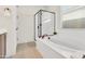 Bright bathroom featuring a soaking tub, glass-enclosed shower, and modern fixtures at 19724 W Palo Verde Dr, Litchfield Park, AZ 85340