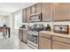 Contemporary kitchen with updated appliances, granite counters, and ample cabinet space at 19724 W Palo Verde Dr, Litchfield Park, AZ 85340