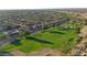 Wide aerial view of a neighborhood with a golf course in the background at 19939 N Golden Barrel Dr, Surprise, AZ 85374