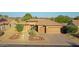 Single-story house with tile roof, two-car garage, and desert landscaping at 19939 N Golden Barrel Dr, Surprise, AZ 85374