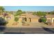 Single-story house with a two-car garage and neatly landscaped yard; view of neighborhood at 19939 N Golden Barrel Dr, Surprise, AZ 85374