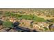 Aerial view showing a neighborhood with homes and a green golf course at 19939 N Golden Barrel Dr, Surprise, AZ 85374