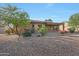 Landscaped backyard with mature trees and a relaxing patio area at 19939 N Golden Barrel Dr, Surprise, AZ 85374