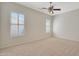 Well-lit bedroom with plantation shutters and neutral wall colors at 19939 N Golden Barrel Dr, Surprise, AZ 85374