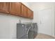 Laundry room with washer, dryer, and upper cabinets at 19939 N Golden Barrel Dr, Surprise, AZ 85374