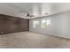 Bright bedroom with neutral carpeting and ceiling fan at 20673 N Marquez Dr, Maricopa, AZ 85138