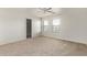 Well lit bedroom with neutral carpeting and ceiling fan at 20673 N Marquez Dr, Maricopa, AZ 85138