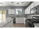 Modern kitchen featuring granite countertops, stainless steel appliances, and white cabinets at 20673 N Marquez Dr, Maricopa, AZ 85138