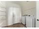 Laundry room with washer, dryer, and ample shelving at 20673 N Marquez Dr, Maricopa, AZ 85138