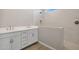 Modern bathroom with double vanity, white cabinets and a walk-in shower at 21011 N 58Th Way, Phoenix, AZ 85054