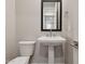 Powder room with pedestal sink and toilet at 21011 N 58Th Way, Phoenix, AZ 85054