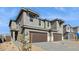 A modern home showcases a spacious three-car garage, stylish stone accents, and professionally designed landscaping at 21016 N 58Th Way, Phoenix, AZ 85054