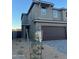 Two-story home with gray exterior, brown garage door, and landscaped front yard at 21016 N 58Th Way, Phoenix, AZ 85054