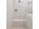 Modern shower with built-in seat and marble-look tile at 21016 N 58Th Way, Phoenix, AZ 85054