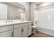 Modern bathroom with double vanity, tiled shower and bathtub at 21023 N 58Th Way, Phoenix, AZ 85054